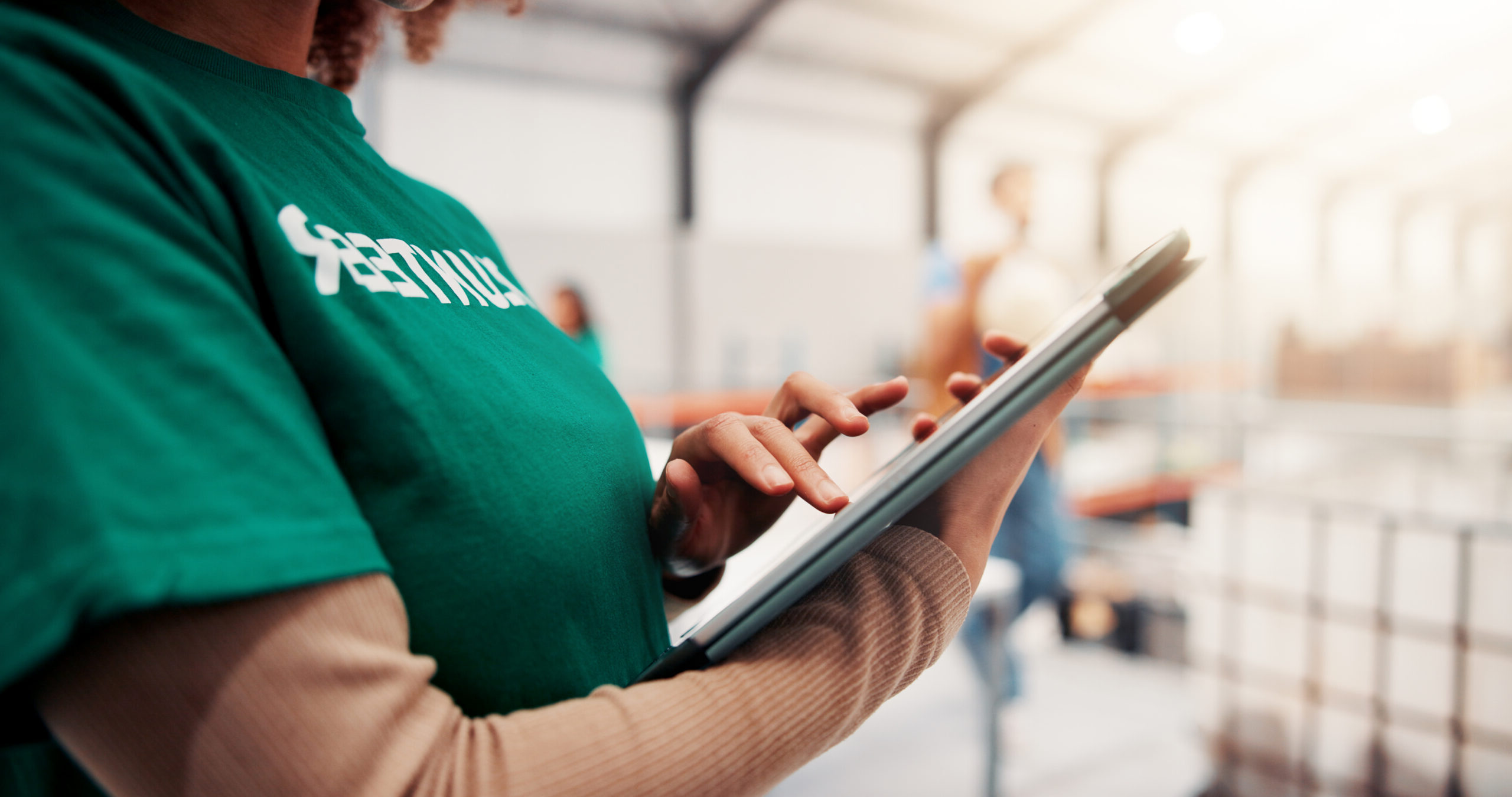 Charity, ngo and tablet with hands of woman in warehouse for non profit, inventory checklist and scroll. Volunteer, social responsibility and food bank program with closeup of person for donation